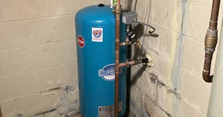 Blue pressure tank in a corner