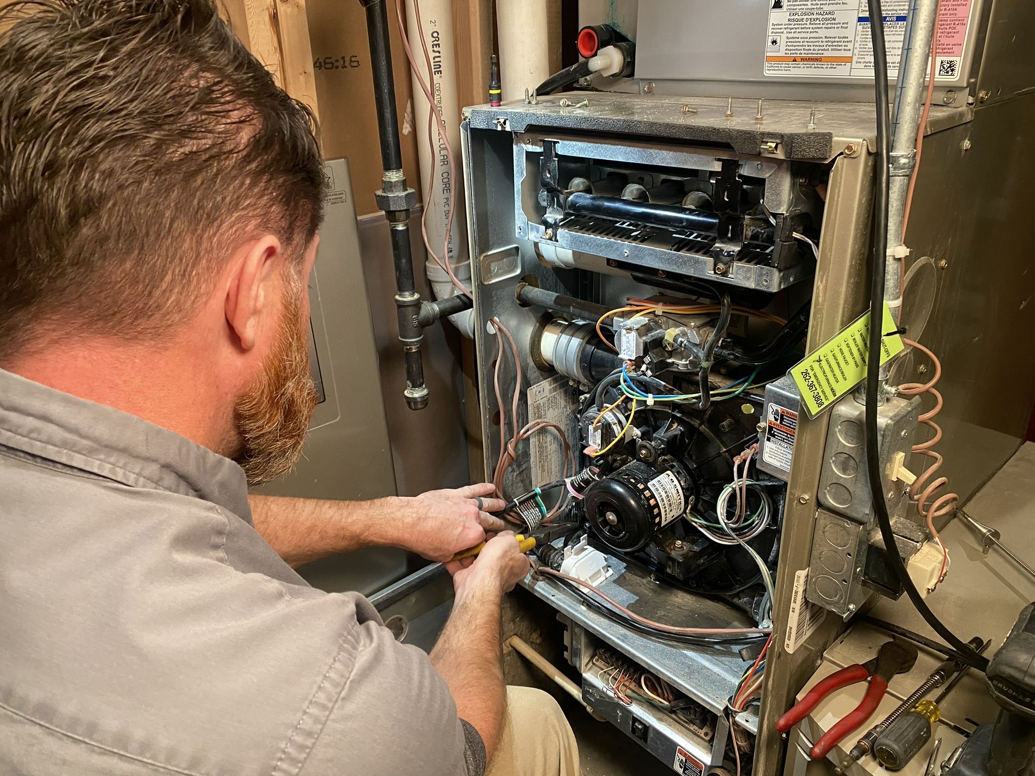 Furnace Repairman from Austin Plumbing, Heating & Air making an emergency furnace repair 