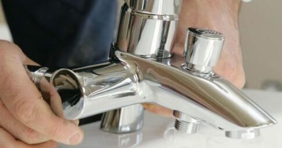 Man installing a faucet