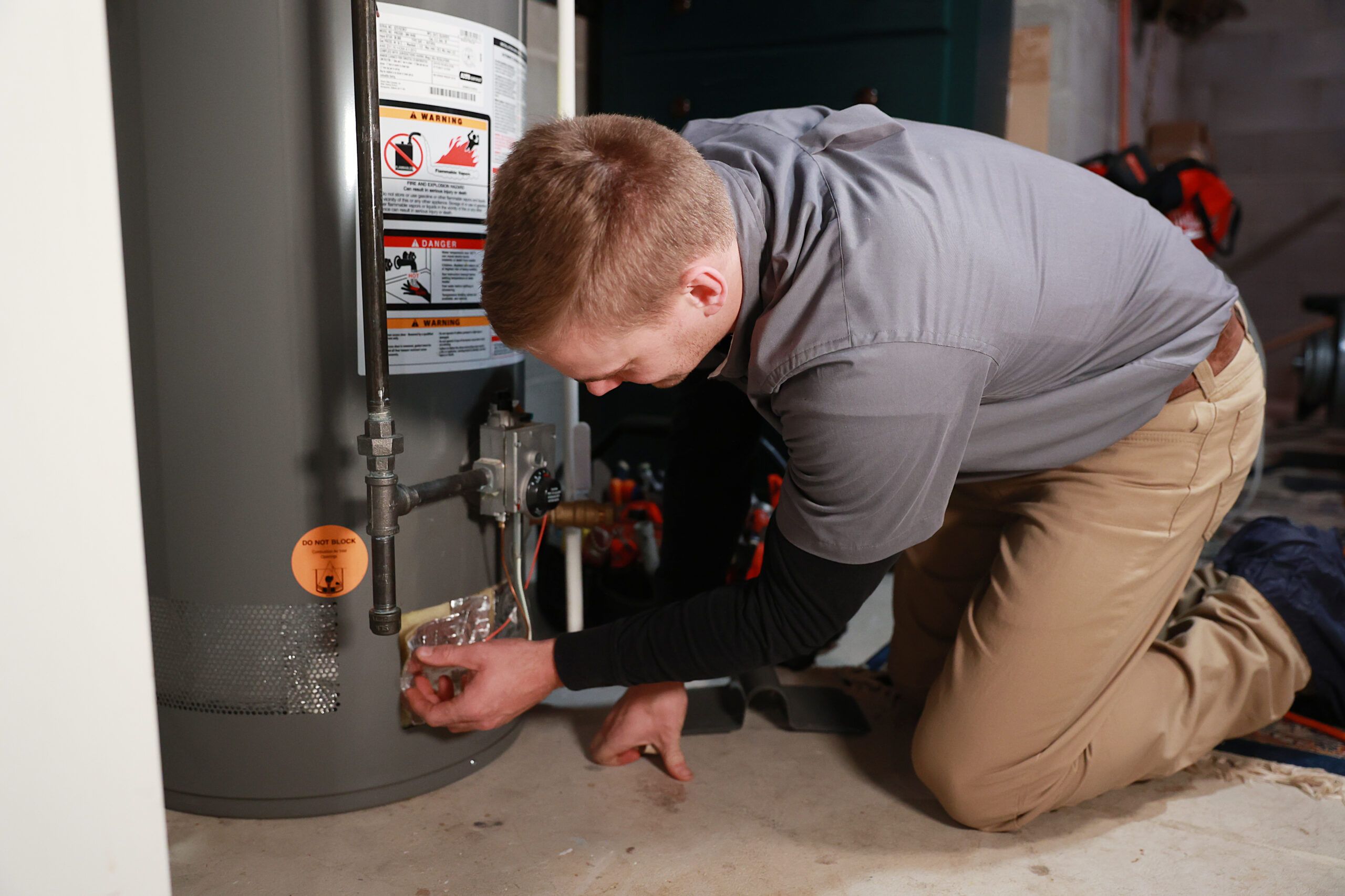 Plumber from Austin Plumbing, Heating & Air making a repair on a water heater