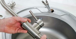 Man with Detached Faucet in hands