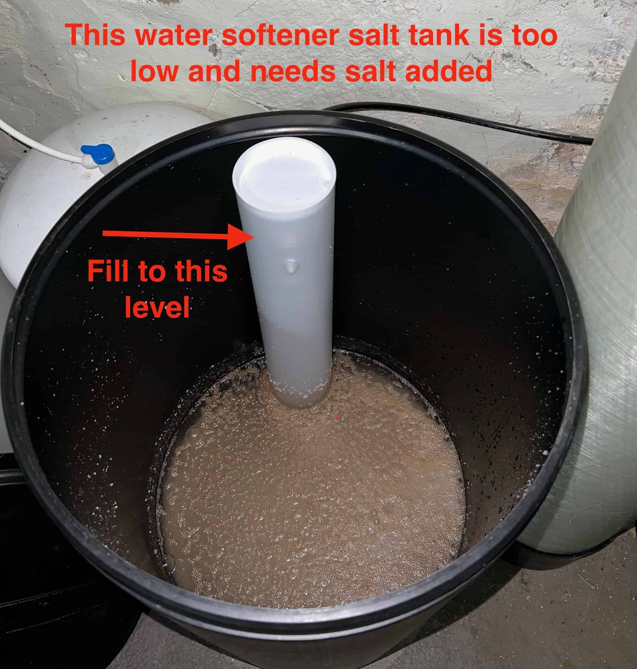 Image of empty salt tank for water softener with proper fill level identified. 
